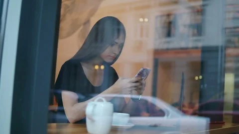 View from the outside of a concentrated young lady with long hair and natural Stock Footage 79527732