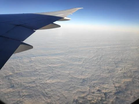 View outside plane window on closed cloud cover Stock Photos