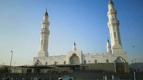 View from outside the Quba mosque with visitors and pigeons scattered Stock Footage 124953720