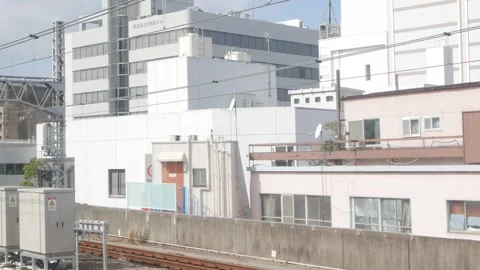 View outside train through train window while moving fast through suburban .. 動画素材 316390715