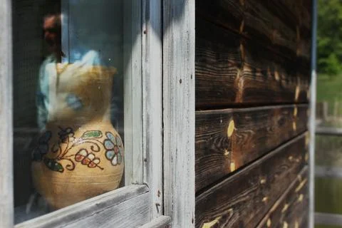 View from outside on vintage hut elements, window, log wall, retro decanter, Foto stock