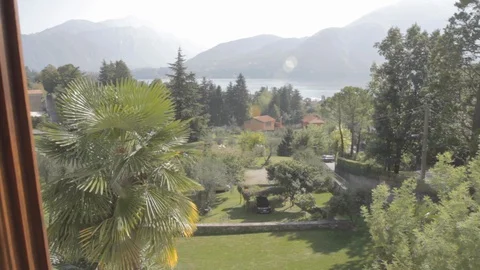 The view outside the window at Lake Como, Green Garden and mountains Video stock 127824418
