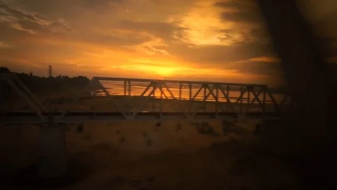 View from outside the windows of an express train, evening with colorful sky Stock Footage 92710638