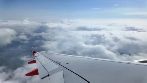 View over aircraft wing to clouds and blue sky Stock Footage 287482721