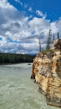 View over Athabasca River flowing from nearby Athabasca Falls, Jasper Nationa Stock Photos