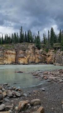 View over Athabasca River flowing from nearby Athabasca Falls, Jasper Nationa Stock Photos