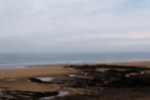 View over the beach at Bude in Cornwall Out of focus. Stock Photos