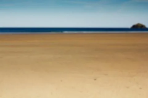 View over the beach at Polzeath in Cornwall Out of focus. Stock Photos