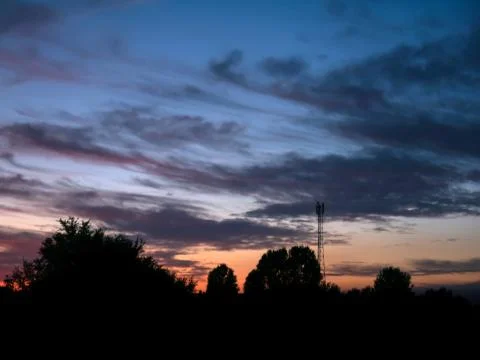 View over a beautiful sunset behind a radio antenna tower. Foto stock