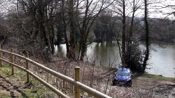 View over car park  next to forest angling pool Stock Footage 85594764