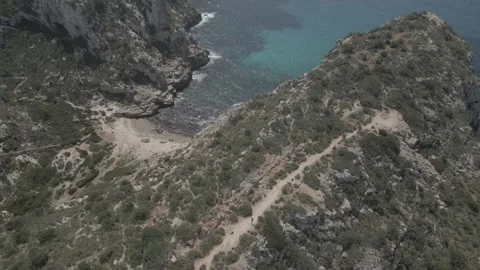 View over cliff reveals beach Stock Footage 305525143