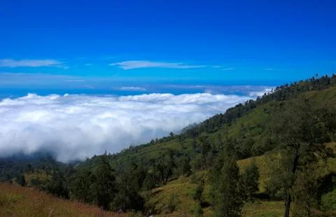 View over clouds from Mountain blue sky Mount Rinjani Lombok Ind Stock Photos