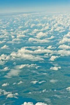 View over the clouds out of an airplane Stock Photos