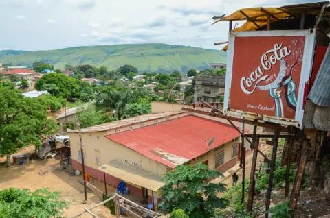 View over the Congolese river town Matadi with buildings and Coca Cola billboard Stock Photos