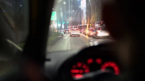 View over the driver's shoulder in a moving car at night 스톡 동영상 126995173