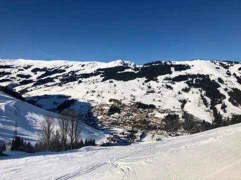 View over empty skiing slopes down in the valley of Saalbach-Hinterglemm Stock Photos