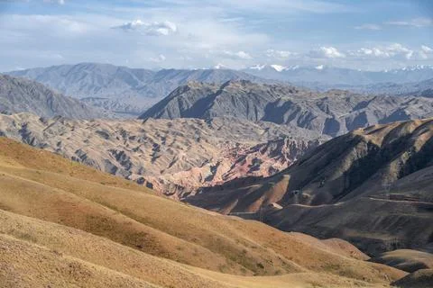 View over eroded mountainous landscape with brown hills mountains and steppe Stock Photos