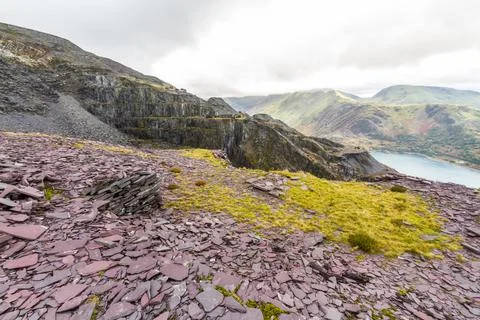 View over high slate quarry to lake and mountains. Stock Photos