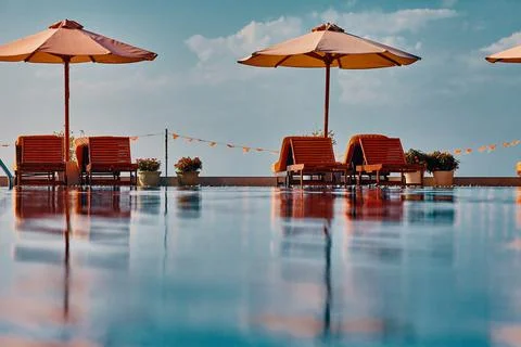 View over the infinity pool to sun loungers and parasols from the bottom point Stock Photos