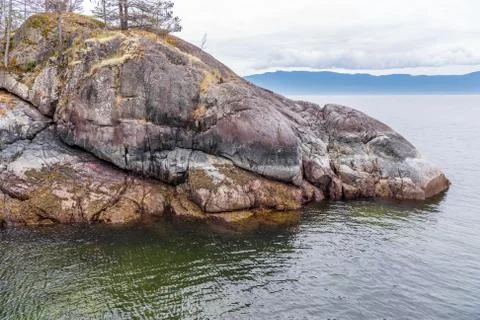 View over Inlet, ocean and island with boat and mountains in beautiful Britis Stock Photos