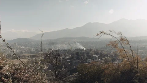 View over Kathmandu Valley from Swayambhunath Stupa, smoke rises Stock Footage