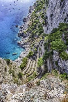 View over Via Krupp, winding cliffside road in Capri island, Italy Stock Photos
