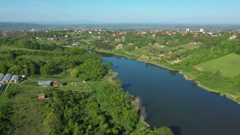 View over lake and houses in grassy woodland Stock Footage 197478053