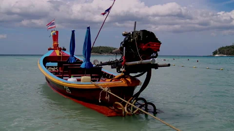 A view over long tail boat while docked near popular beach at Phuket Stock Footage 141159111
