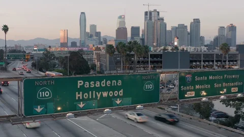 The view over Los Angeles freeway. Downtown towers are seen ahead. Evening time. Video stock 128097262