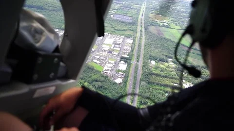View over man's shoulder out window of helicopter Stock Footage 84083268