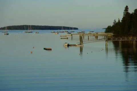 A view over marina with multiple small fishing boats between wooded islands Stock Photos