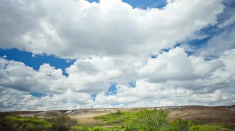 View over the meadows and hills in the summer sky with clouds Video stock 30997237