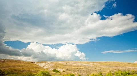 View over the meadows and hills in the summer sky with clouds Stock Footage 30997761