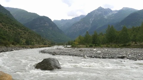 A view over mountains and a river with a quick flow Stock Footage 94328396