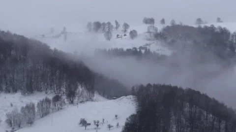 View over the mountains which are loaded with snow with wisps of fog that 722 Video stock 58908543