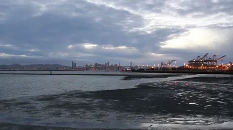 View over the mud flats of the bay, bay bridge and San Francisco Stock Footage 35008602