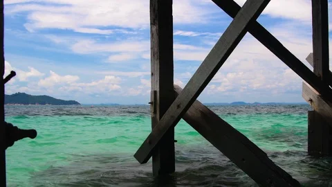View over the ocean from under a boardwalk Stock Footage 115898731