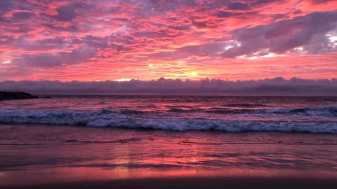 View over the ocean with waves during twilight with pink color at sunset Stock Footage 120618962
