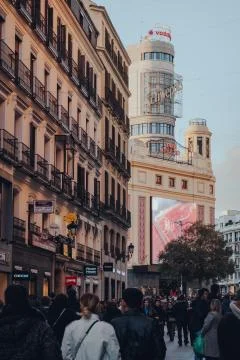 View over people of Edificio Capitol on Gran Via, Madrid, Spain, shallow focu Stock Photos