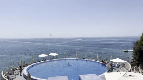 View over the pool on tourists parasailing in the sea Video stock 200969007