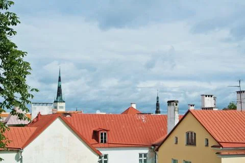 A view over red tile roofs of white and yellow houses of Tallin Old town, Est Stock Photos