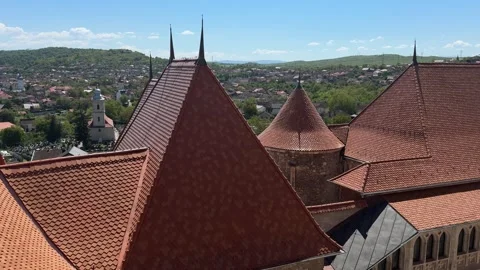 View Over Red Tile Rooftops of Corvin Castle Toward Hunedoara Romania 4K Stock Footage 338194770