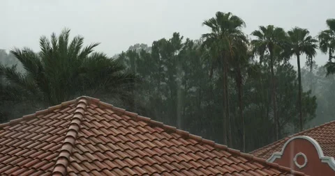 View over a red tiled roof of a typhoon or thunderstorm Stock Footage 157302885