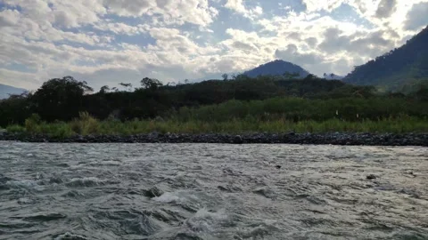 View over a river with forest, stones and mountains Vidéo 282217440