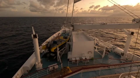 View over sailing ship bow-sailing into sunset Stock Footage 232949882