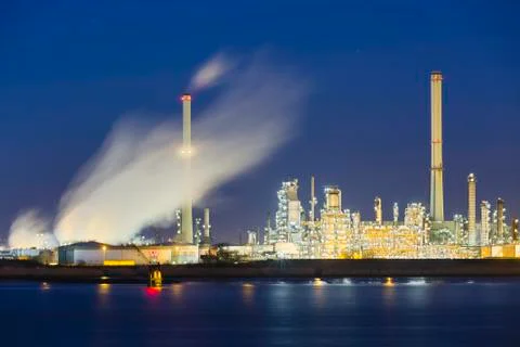 View over the Scheldt river in Antwerp, Belgium to a large oil refinery with  Stock Photos