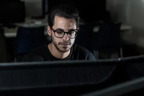 View over a screen of the face of a young computer science student working with 스톡 사진