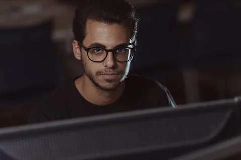 View over a screen of the face of a young computer science student working with 스톡 사진