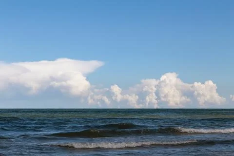 View over the sea far below, white clouds Stock Photos