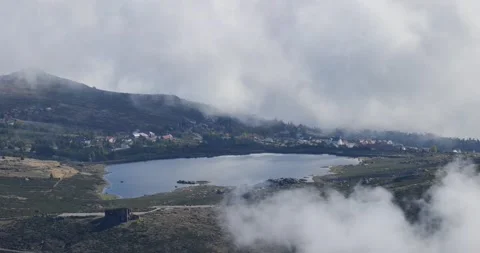 View over Serra da Estrela landscape with a lake and houses around Stock Footage 230177006